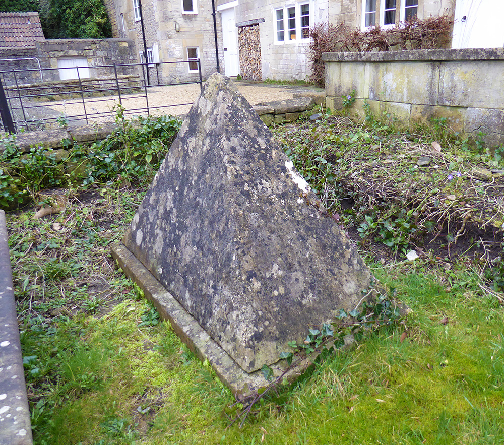 the story goes that the man buried here requested the unusually shaped tombstone to prevent his widow dancing on his grave!
