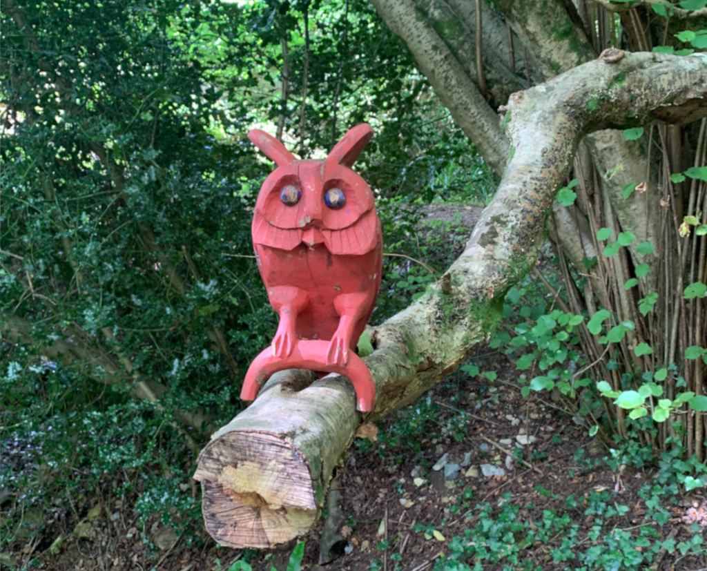 A carved wooden owl in the woods