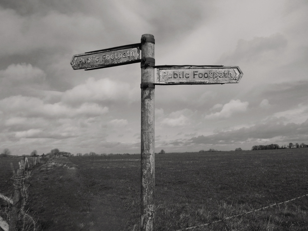 One of many charming old footpath signs we come across.