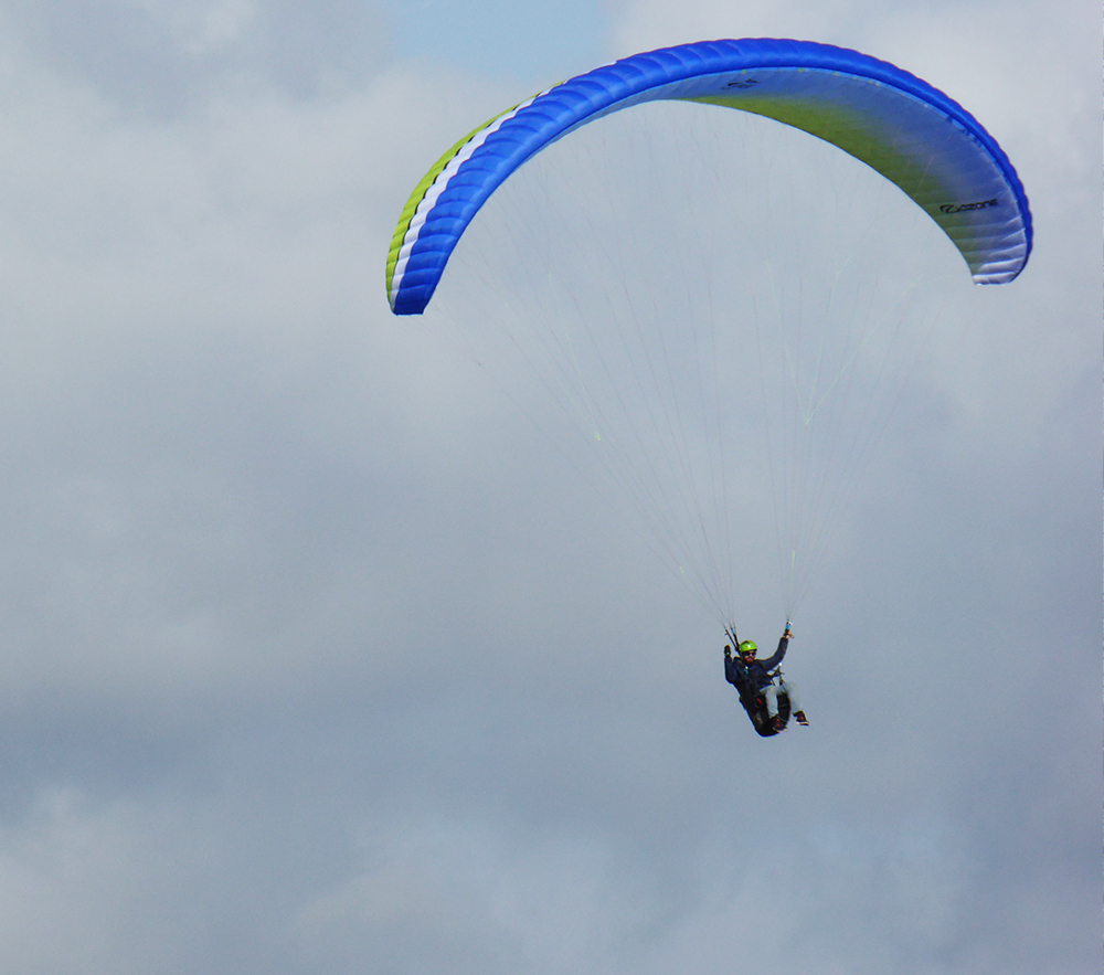 A paraglider floating over the white horse